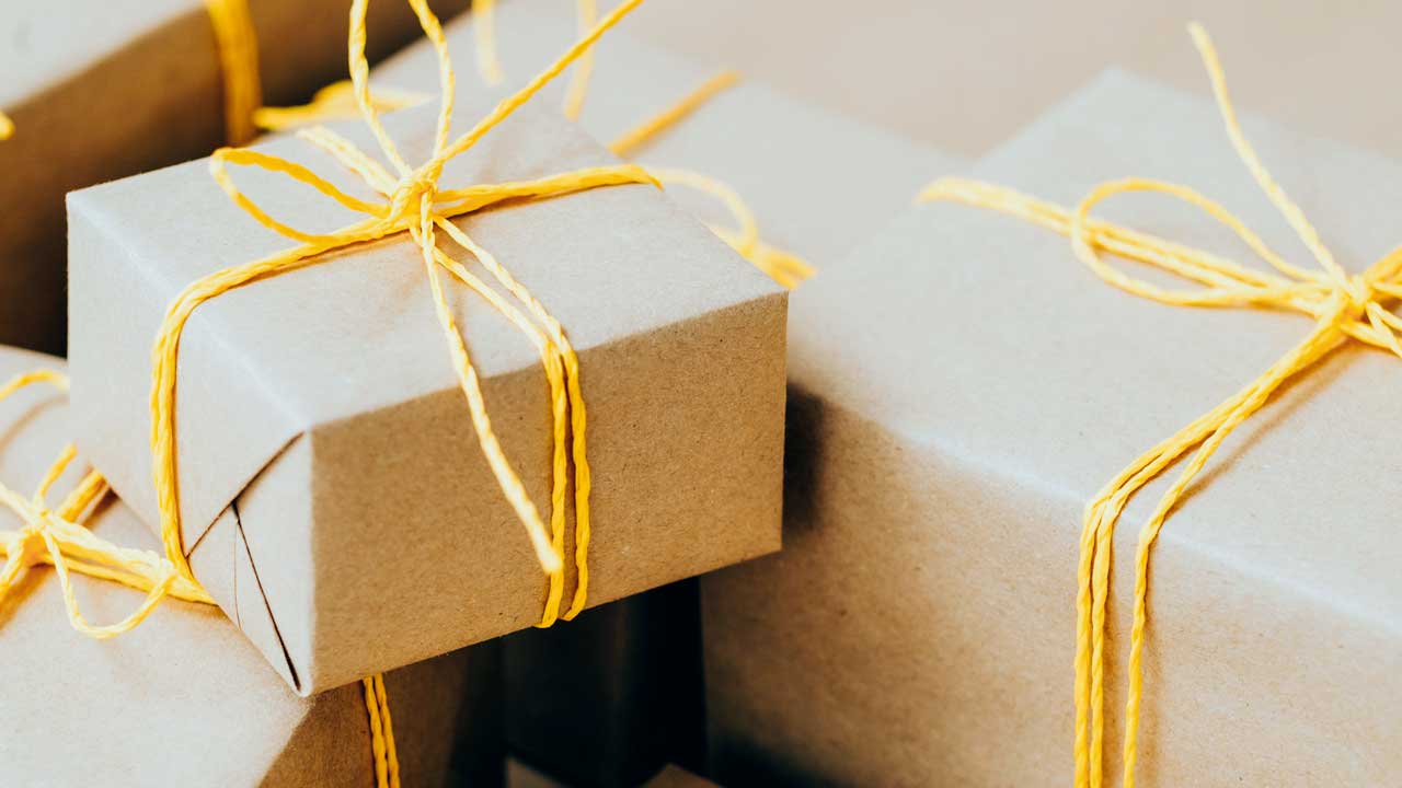 Geschenke in braunem Packpapier und mit gelber Schnur